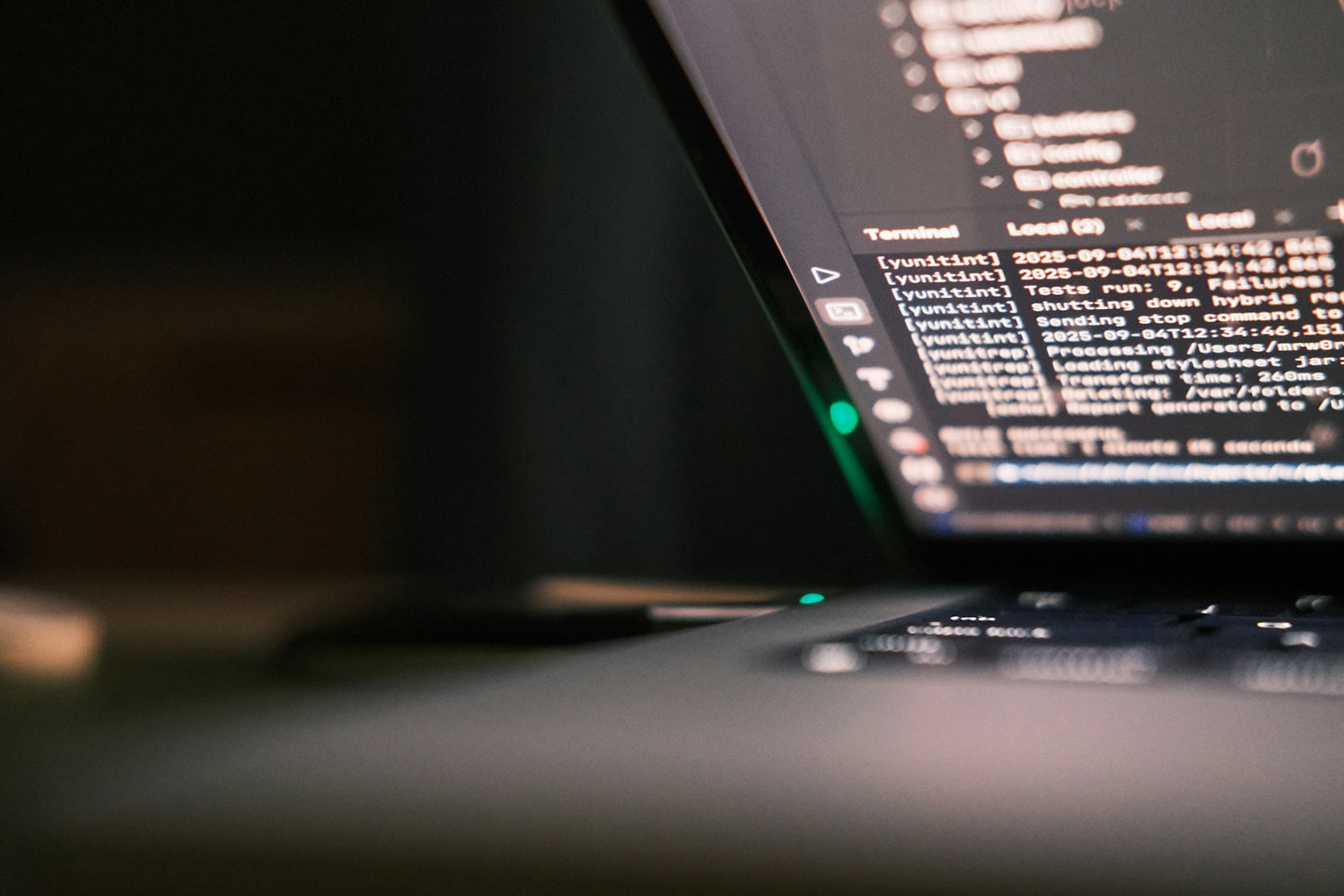Code on a dark monitor, soft ambient light.